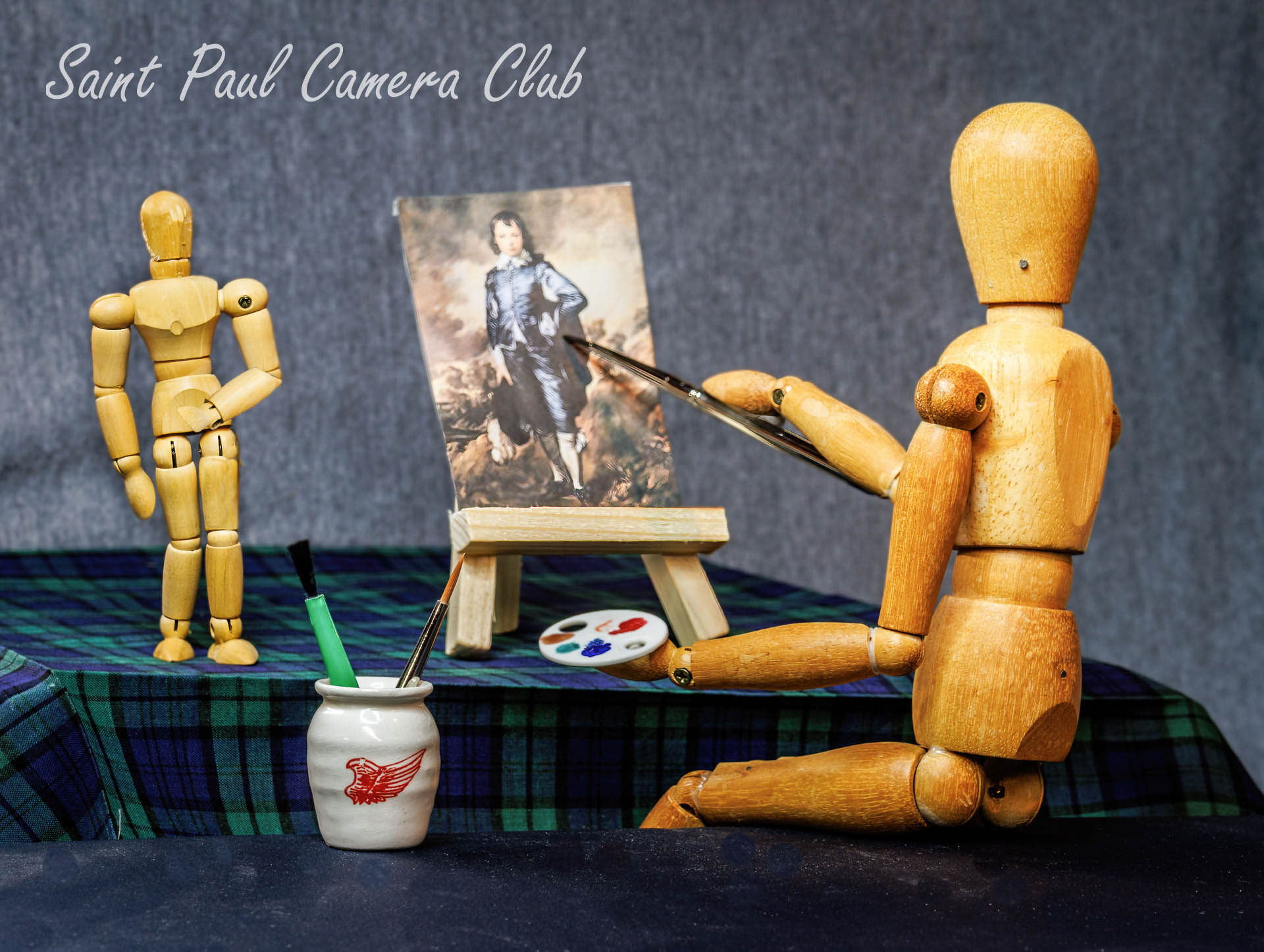 Still life of wooden figures of a painter and subject.