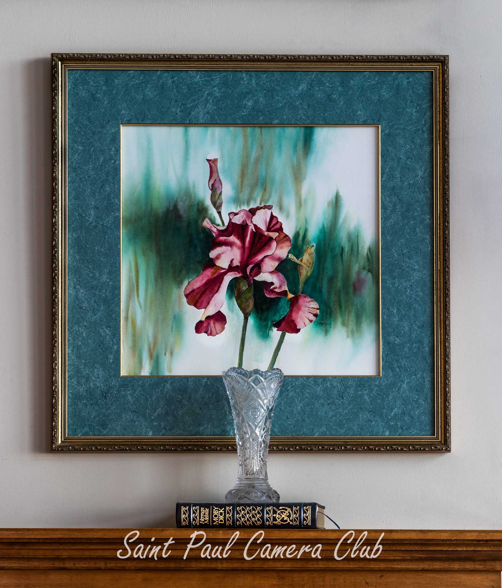 Still life with a flower blending into a painting.